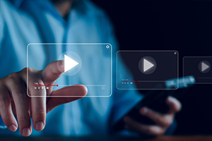 a man pressing play on a video icon floating in the air